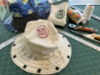 Photo of sample bucket hats featuring fabric that was printed, laser-cut, and sewn in the RDC prototype lab.